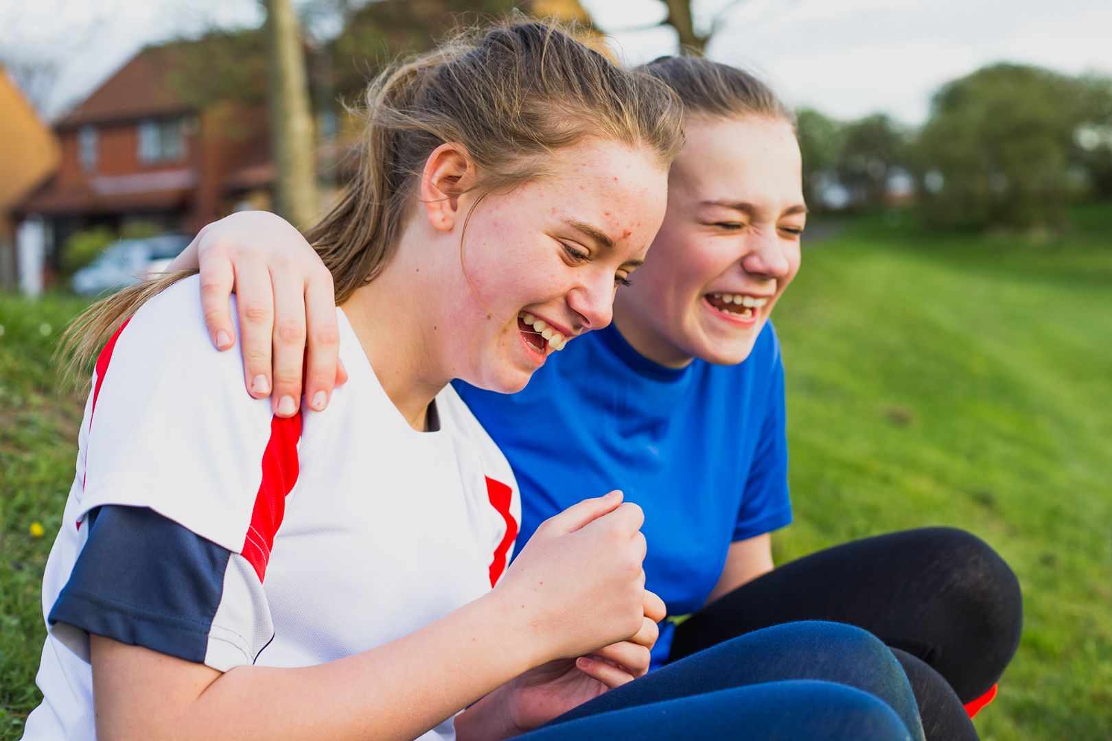 Two young girls smiling and laughing together